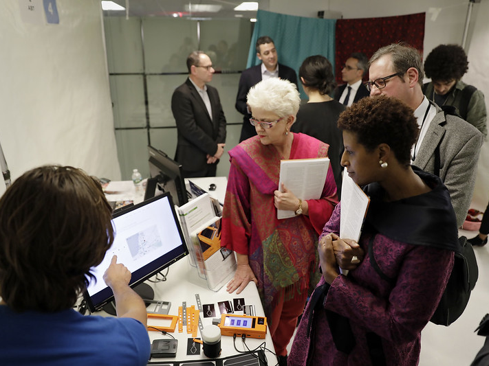 Simulation participants listen as a provider helps participants understand the technology and prepares them to test one of the eight blockchain solutions being presented.  Photo: UN Women/Ryan Brown